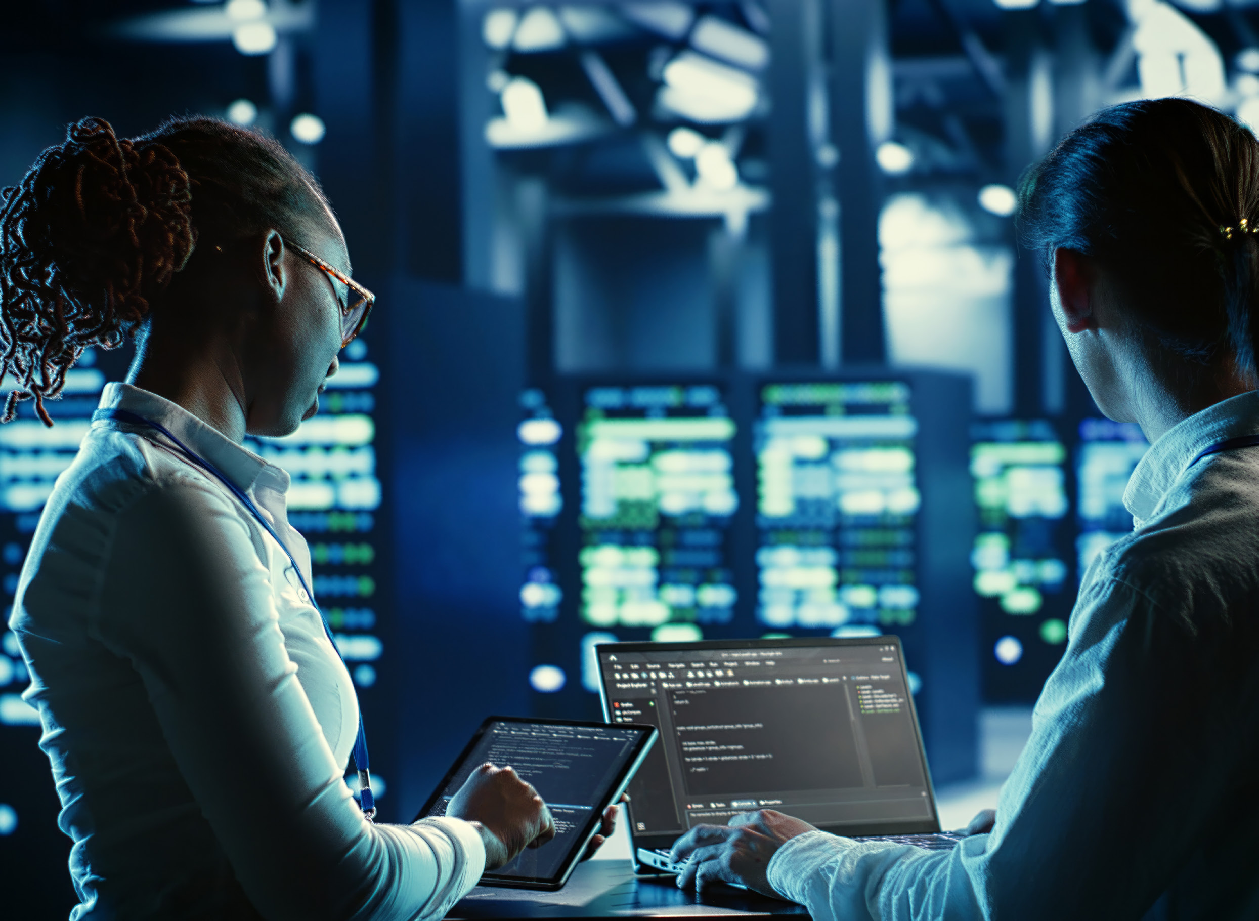Engineers reviewing data in server room